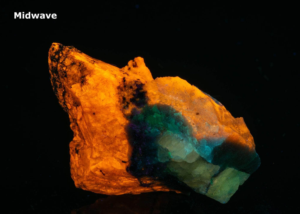 A mix of non-fluorescing ussingite and bright fluorescent sodalite, minor tugtupite from Greenland.