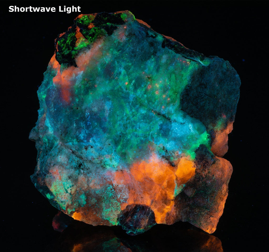 A mineral specimen of fluorescent sodaite with minor tugtupite from Greenland shown under UV light.