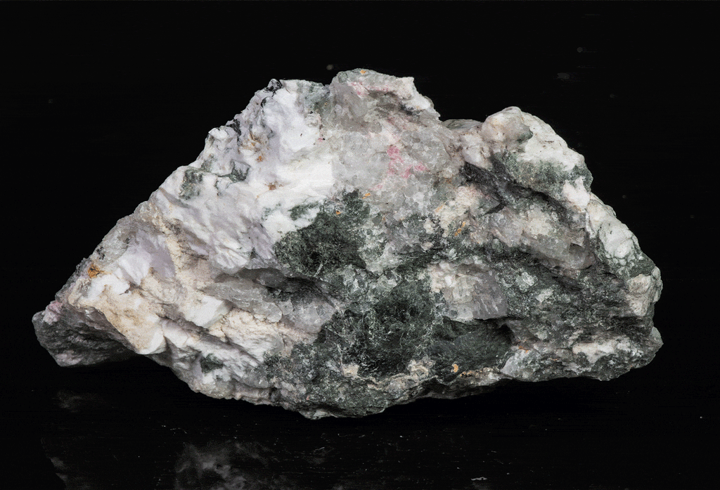 a fluorescent mineral specimen of tugtupite, chkalovite displaying tenebrescence