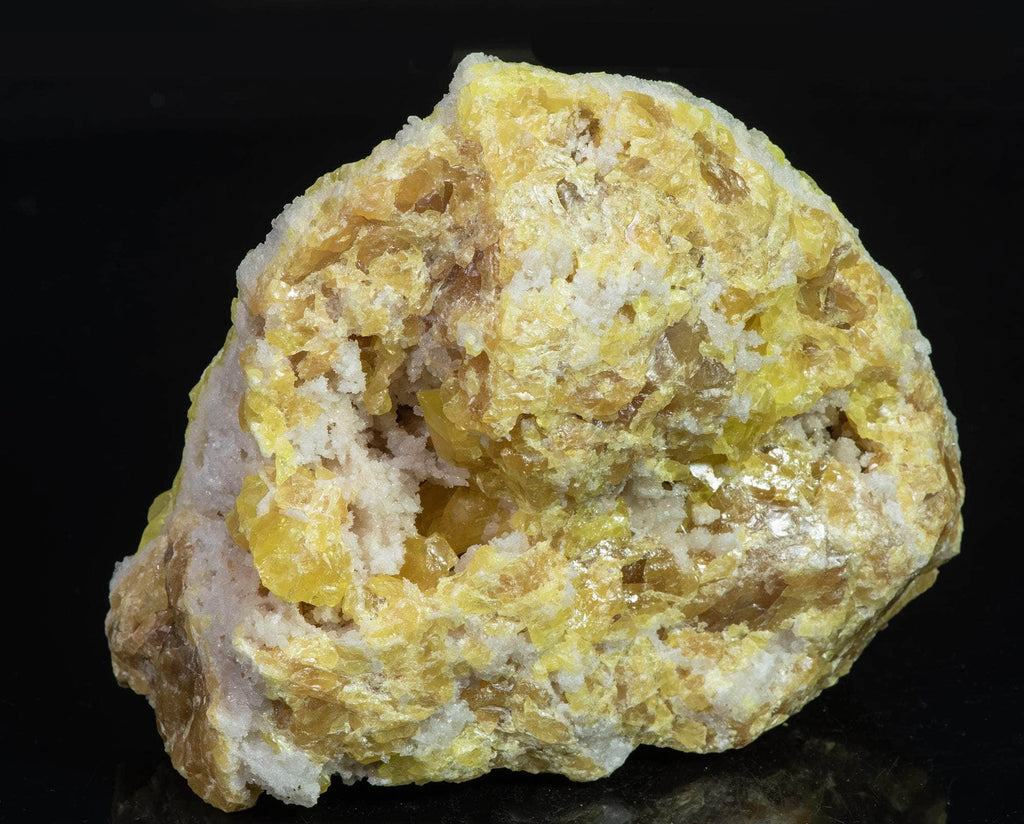 Yellow sulphur crystals sit atop an aragonite matrix