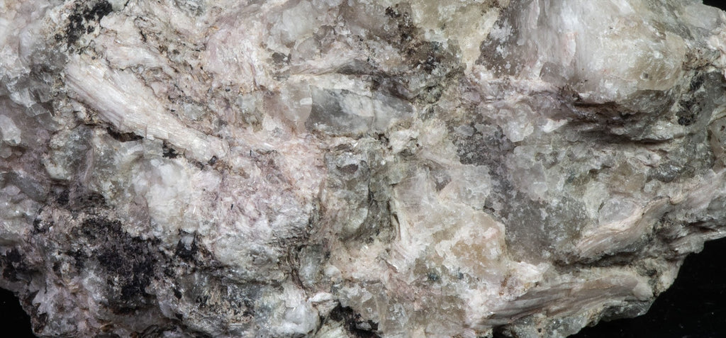 A mineral specimen of sorensenite crystals embedded in matrix