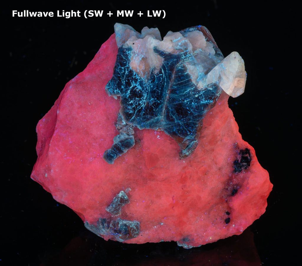 A mineral specimen of blue “hauyne” atop a matrix of calcite from Afghanistan