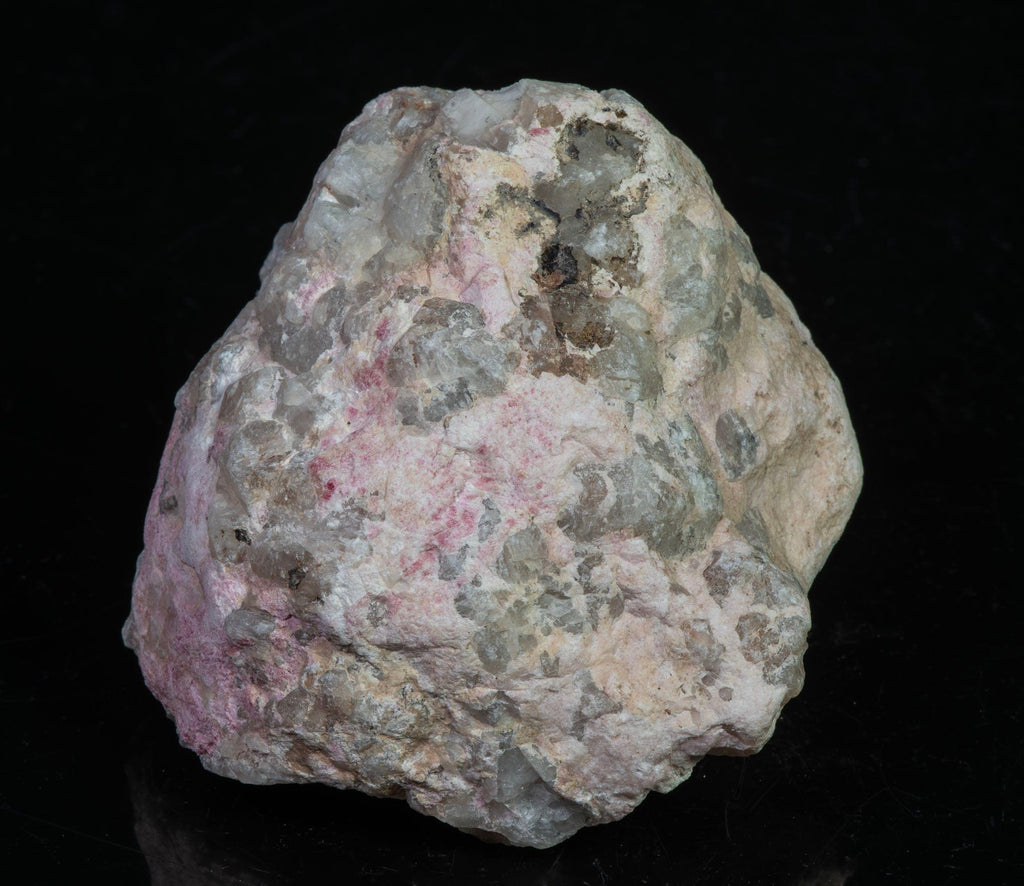 A mineral specimen of bright cherry red tugtupite from Greenland