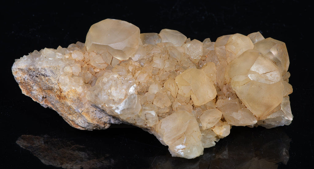 A mineral specimen of honey calcite crystals