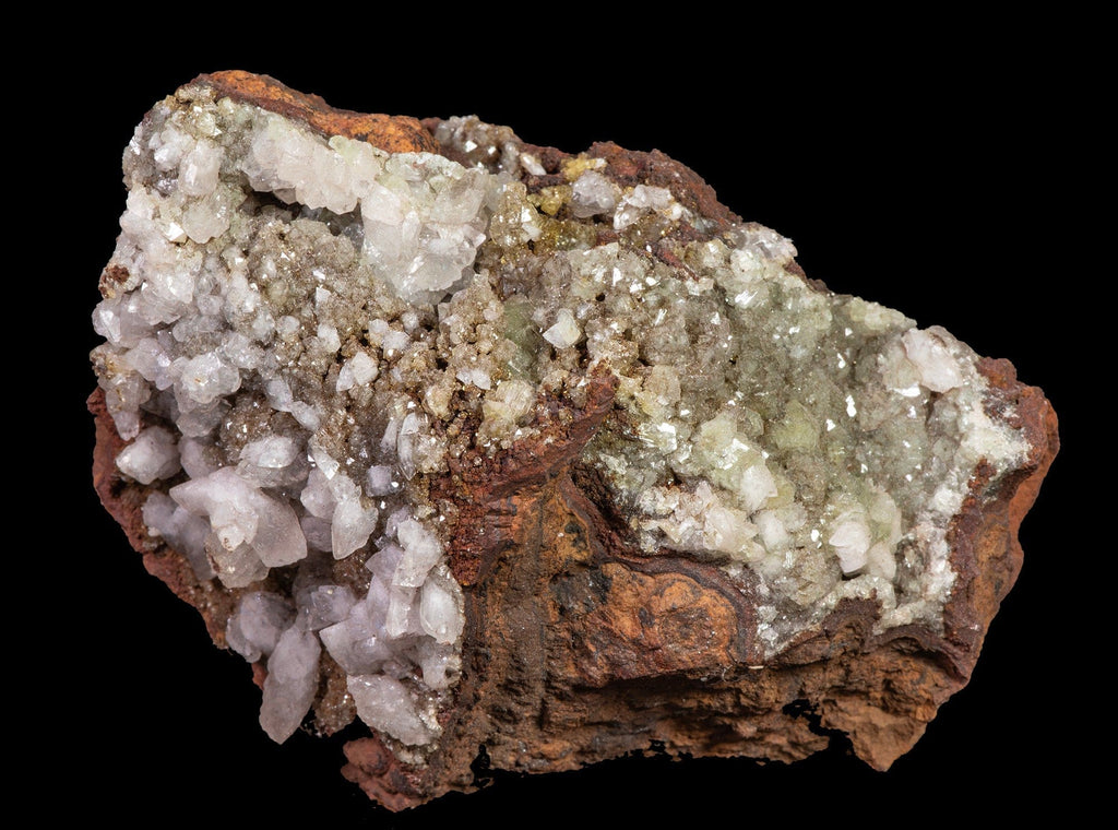 Sparkling, yellow-green, adamite crystals embedded in a limonite matrix along with larger, well-formed, white calcite crystals