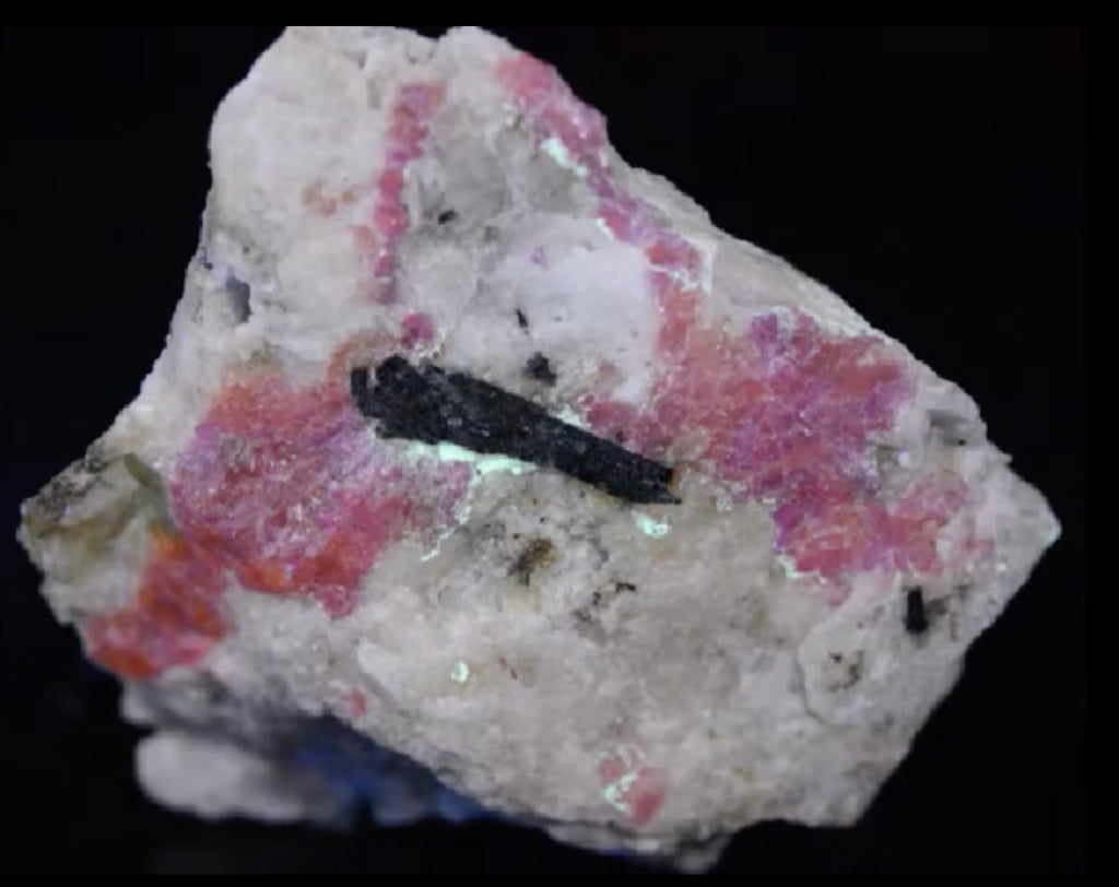 a piece of fluorescent sodalite hackmanite showing its tenebrescence