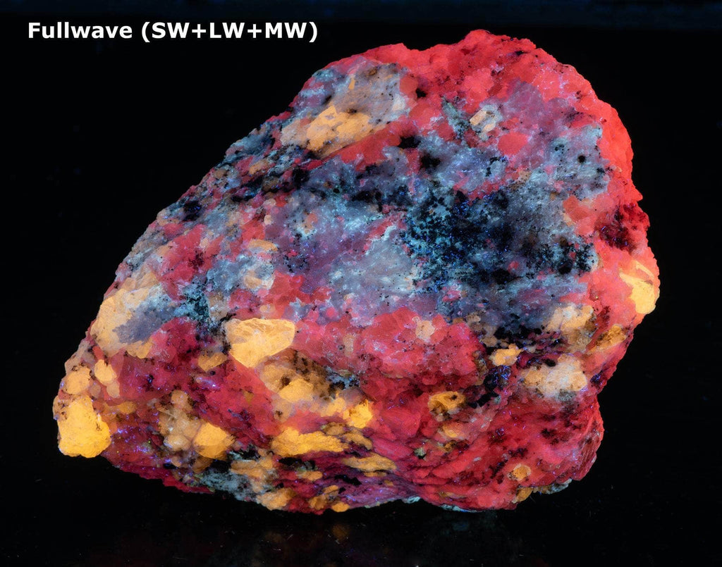 A nice specimen with Marialite (scapolite) crystals, fluorescent a bright yellow longwave, on a calcite matrix.