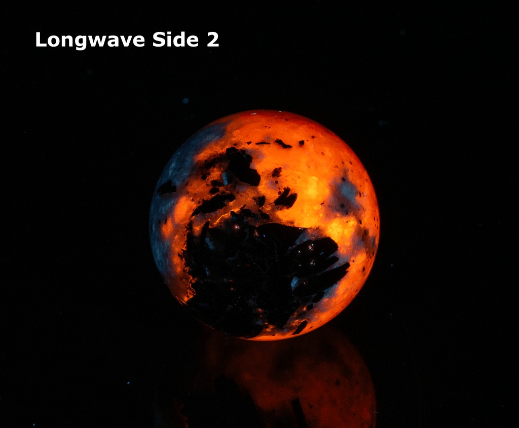 An incredibly bright and colorful, fluorescent sodalite sphere from Greenland