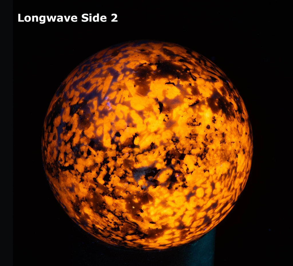 A sphere of fluorescent sodalite, brightest under longwave.