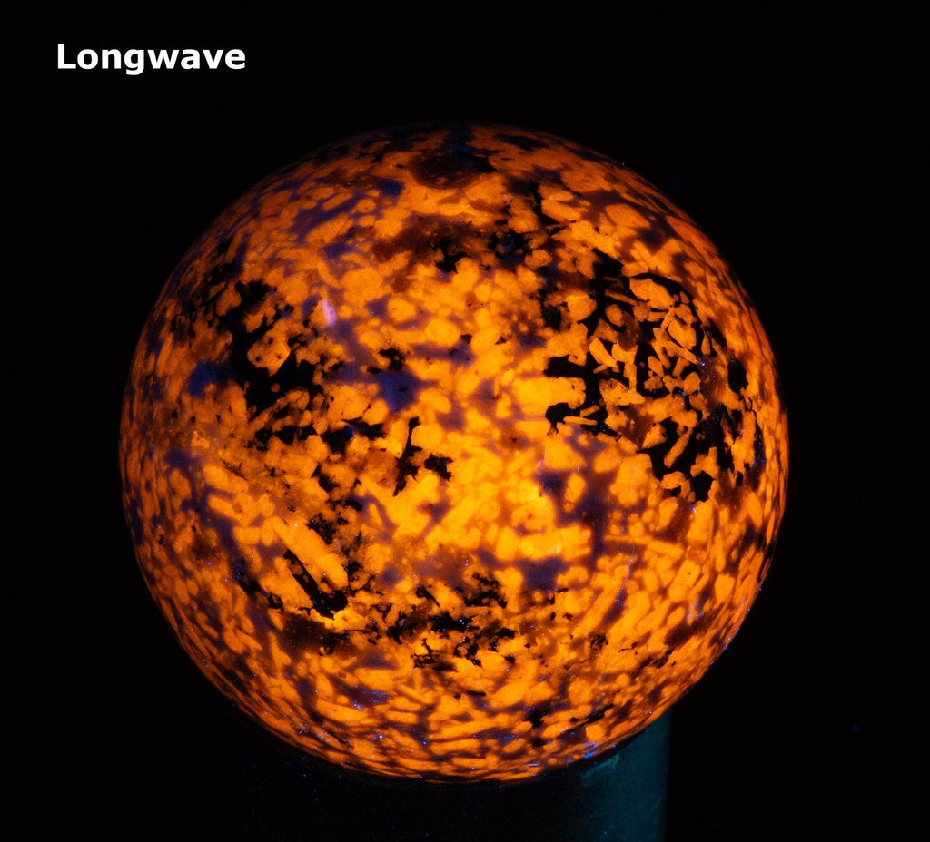 A sphere of fluorescent sodalite, brightest under longwave.
