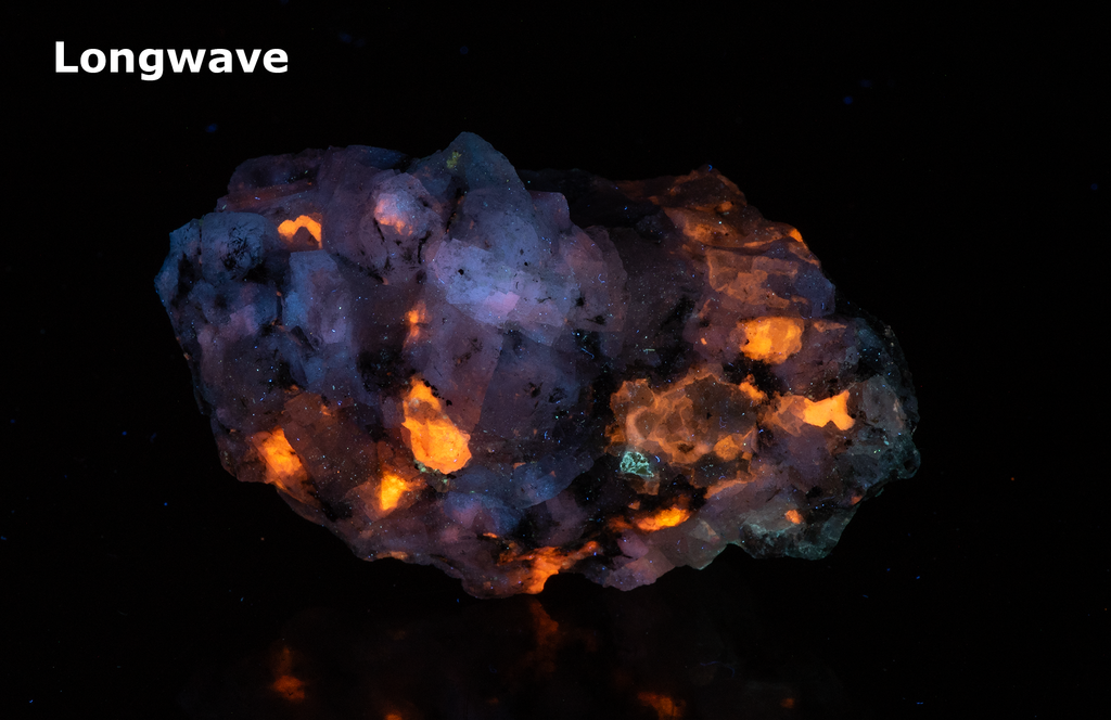 A piece of our highly sought after "Fantasy Rock". This piece features rich tugtupite that fluoresces a deep cherry red under shortwave UV.
