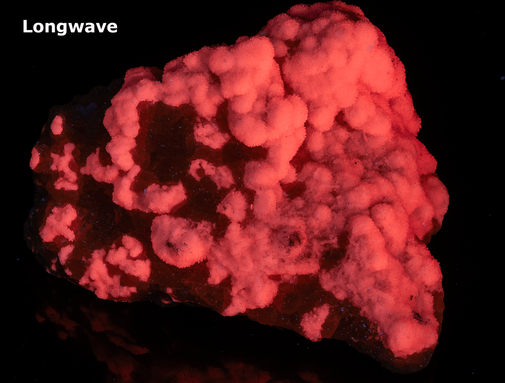 Yellow sulphur crystals sit atop an aragonite matrix