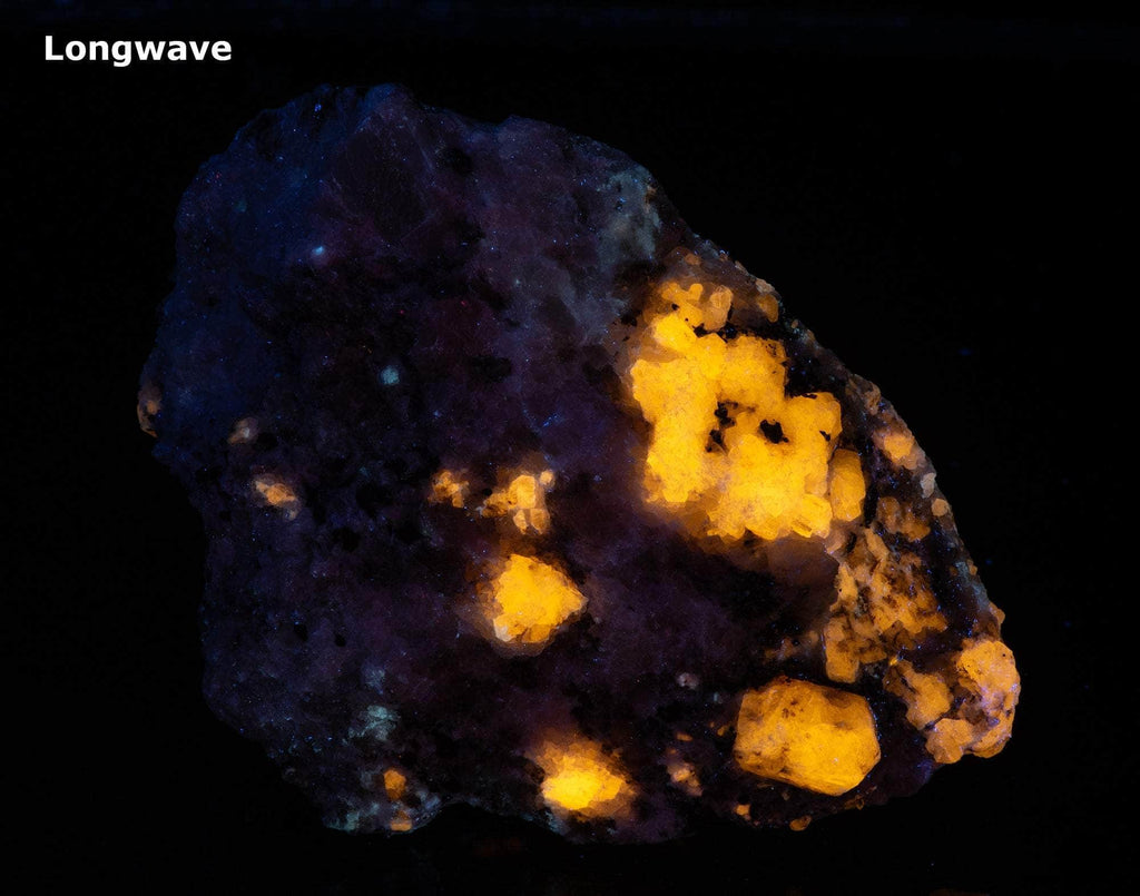 A nice specimen with Marialite (scapolite) crystals, fluorescent a bright yellow longwave, on a calcite matrix.
