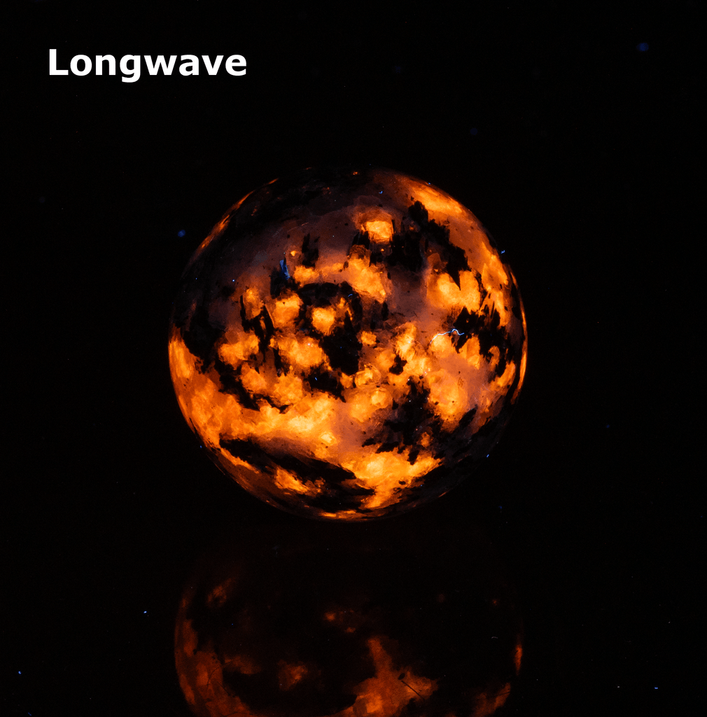 The main minerals on this sphere are blue analcime, orange fluorescent sodalite, black arfvedsonite crystals