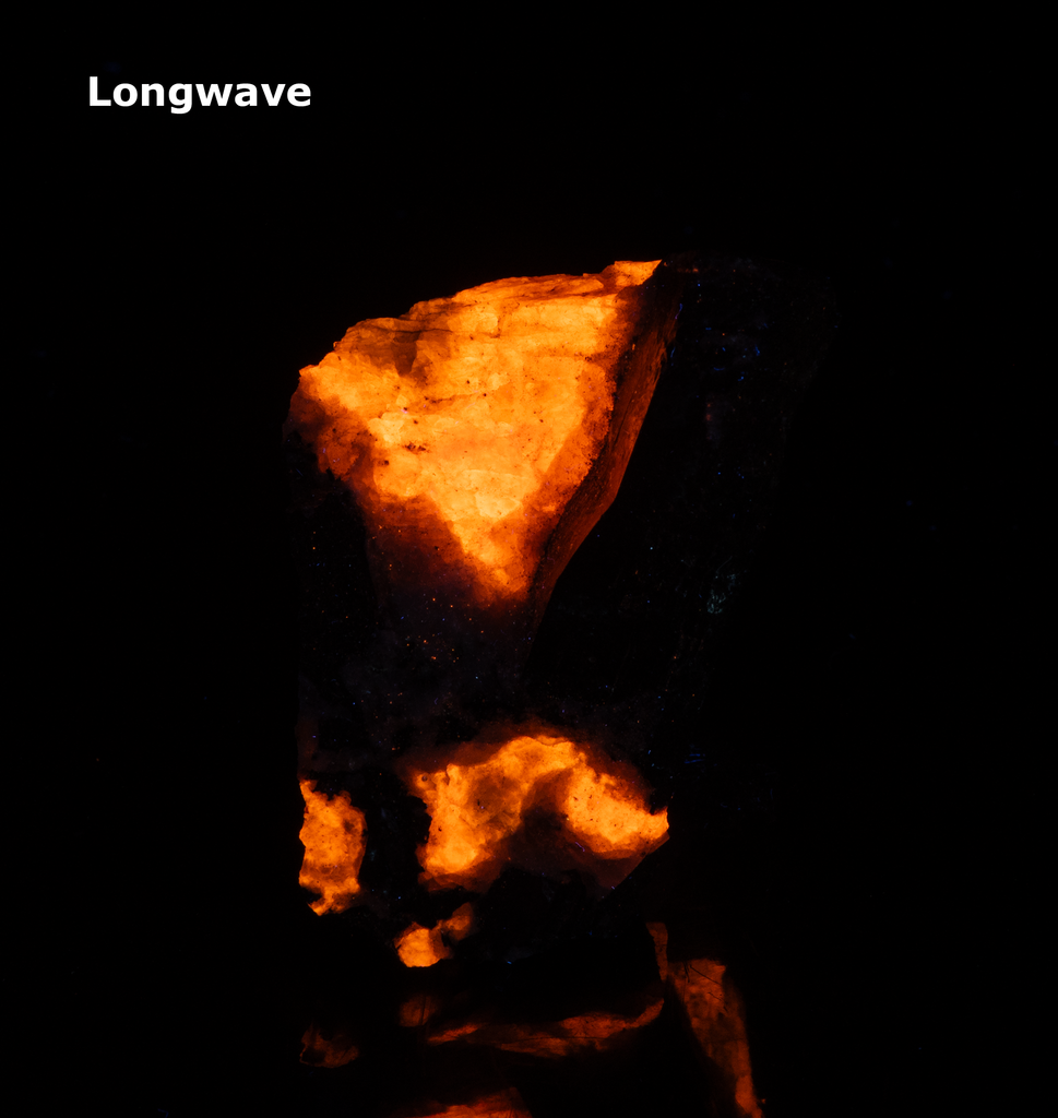 tenebrescent and fluorescent sodalite with an arfvedsonite crystal