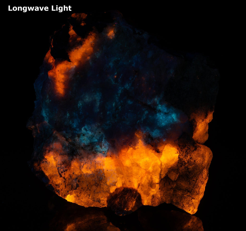 A mineral specimen of fluorescent sodaite with minor tugtupite from Greenland shown under UV light.