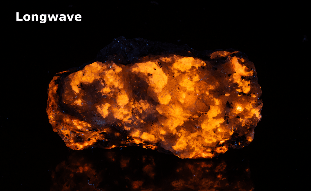 A piece of our highly sought after "Fantasy Rock". This piece features rich tugtupite that fluoresces a deep cherry red under shortwave UV.