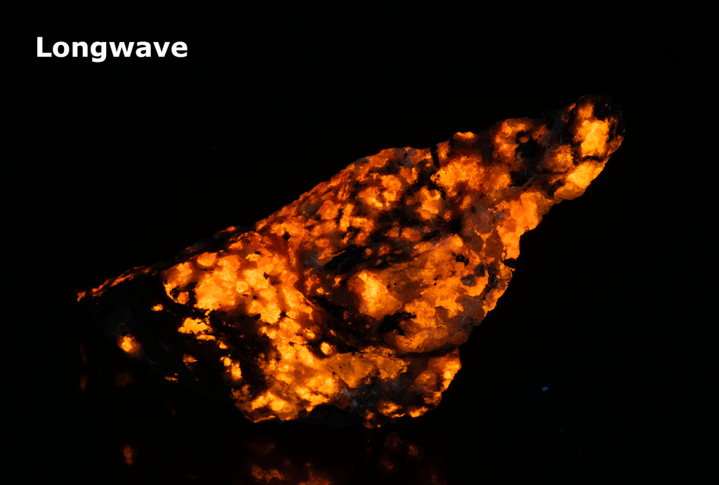 tugtupite (cherry red under shortwave UV light), fluorecent sodalite (orange) and black arfvedsonite
