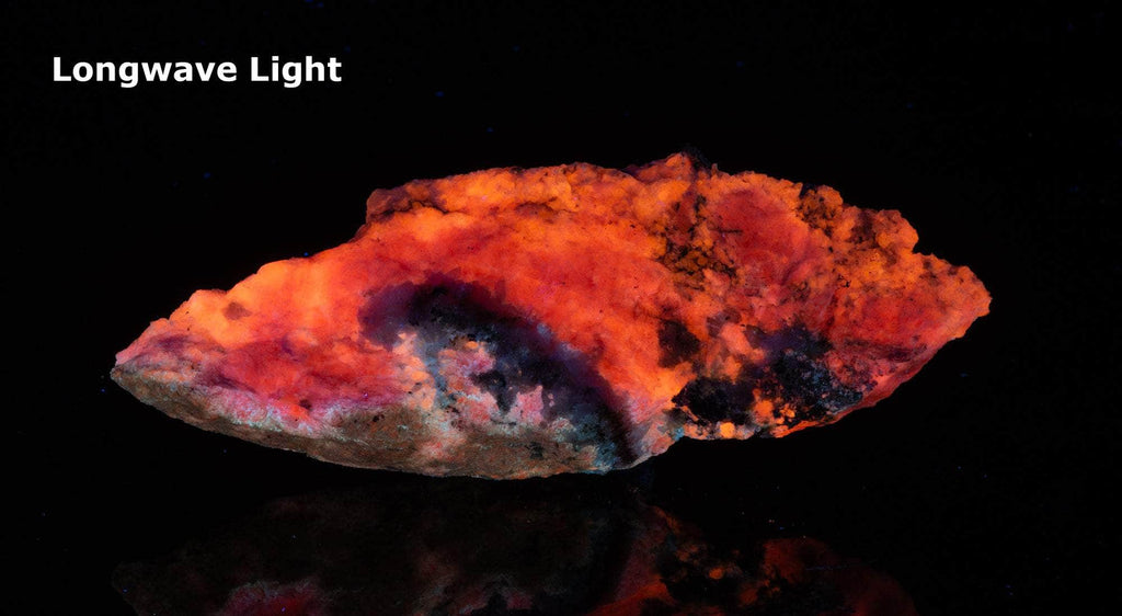 gem red tugtupite under longwave UV light