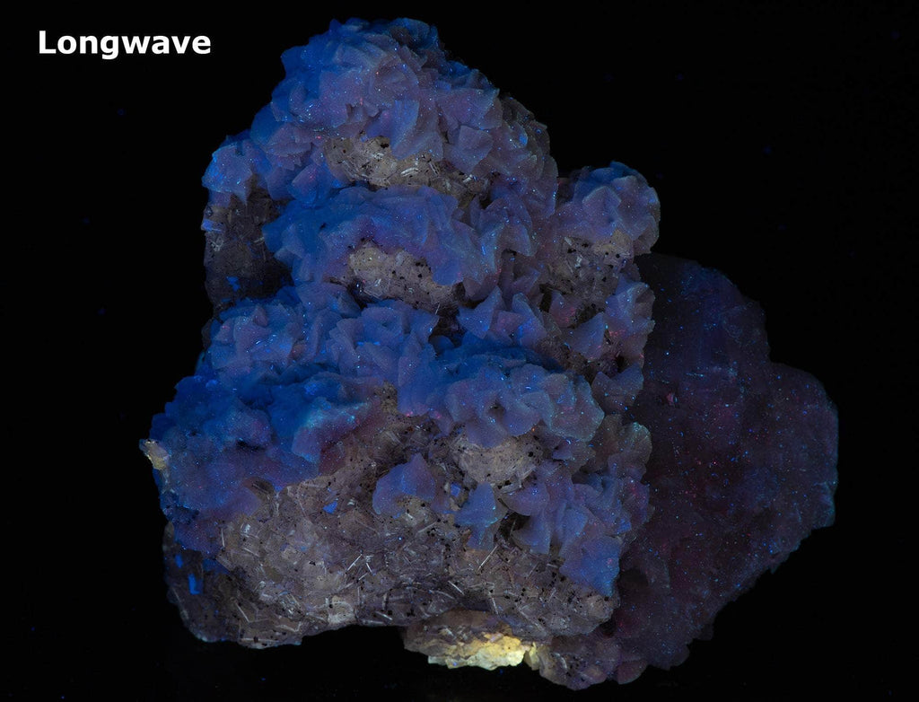  calcite in two different habits along with cubic honey brown fluorite crystals. 