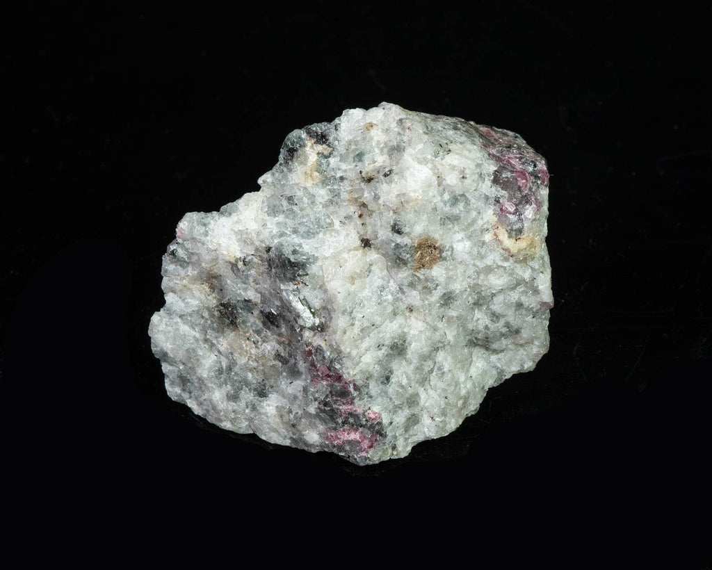 A deeply tenebrescent hackmanite sodalite specimen with minor tugtupite