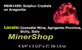 Yellow sulphur crystals sit atop an aragonite matrix