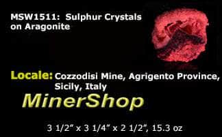 Yellow sulphur crystals sit atop an aragonite matrix