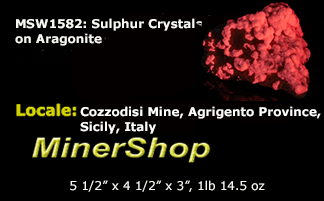 Yellow sulphur crystals sit atop an aragonite matrix