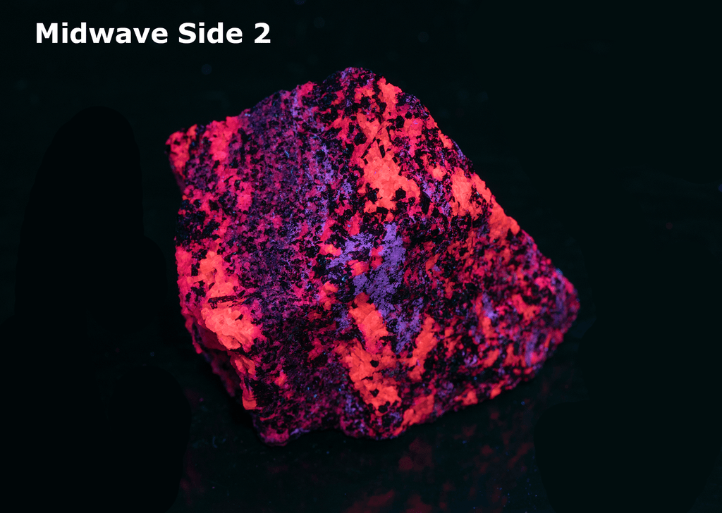 Reddish-brown pyrochlore crystals throughout a white calcite matrix