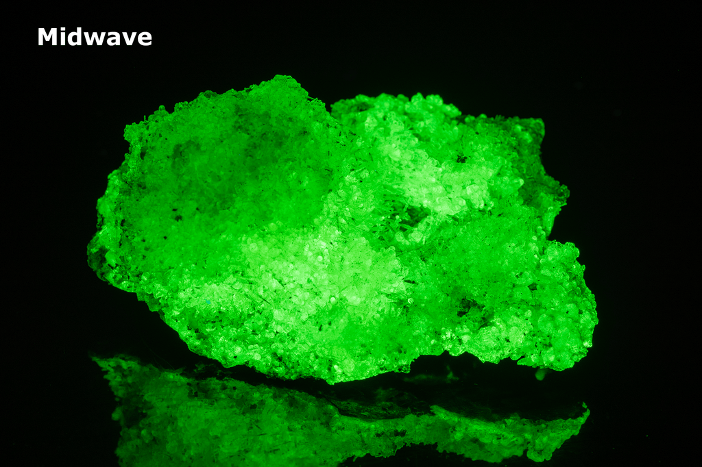 Bright green opal specimen. The hyalite opal shows a bright green fluorescent response under both shortwave and longwave UV.