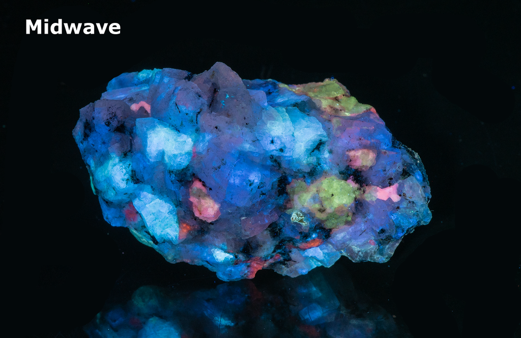 A piece of our highly sought after "Fantasy Rock". This piece features rich tugtupite that fluoresces a deep cherry red under shortwave UV.