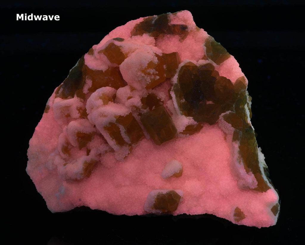 Yellow sulphur crystals sit atop an aragonite matrix