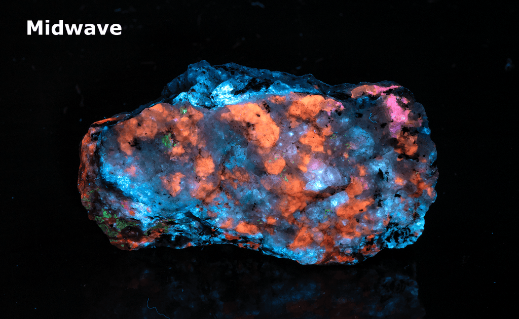 A piece of our highly sought after "Fantasy Rock". This piece features rich tugtupite that fluoresces a deep cherry red under shortwave UV.