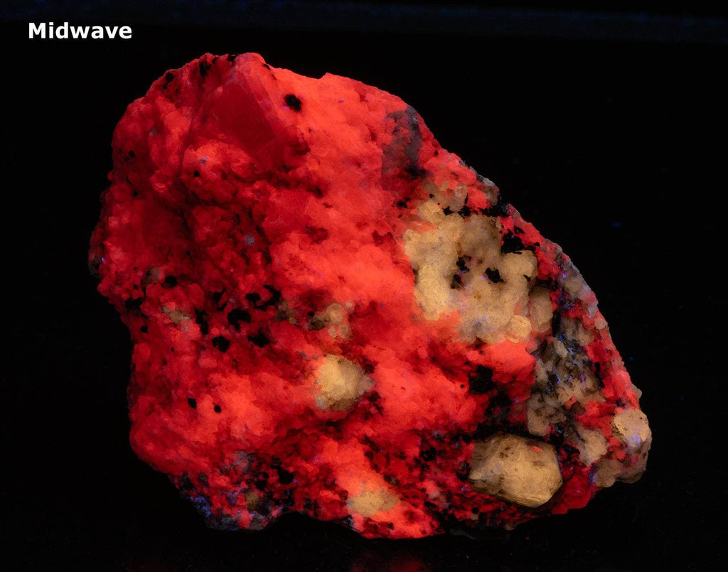 A nice specimen with Marialite (scapolite) crystals, fluorescent a bright yellow longwave, on a calcite matrix.