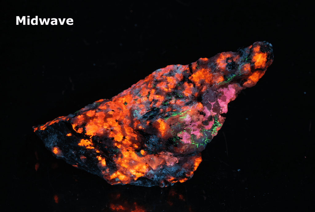 tugtupite (cherry red under shortwave UV light), fluorecent sodalite (orange) and black arfvedsonite