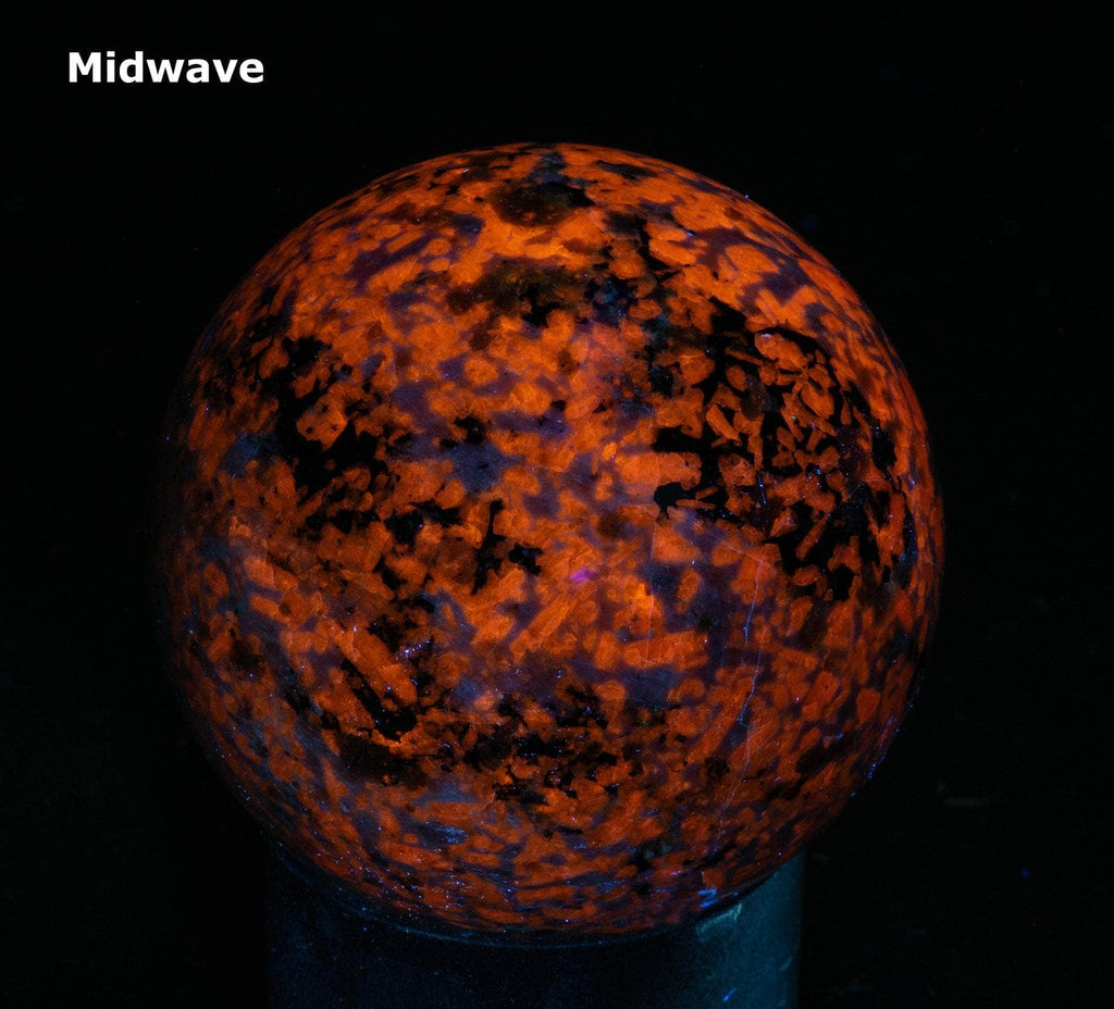 A sphere of fluorescent sodalite, brightest under longwave.