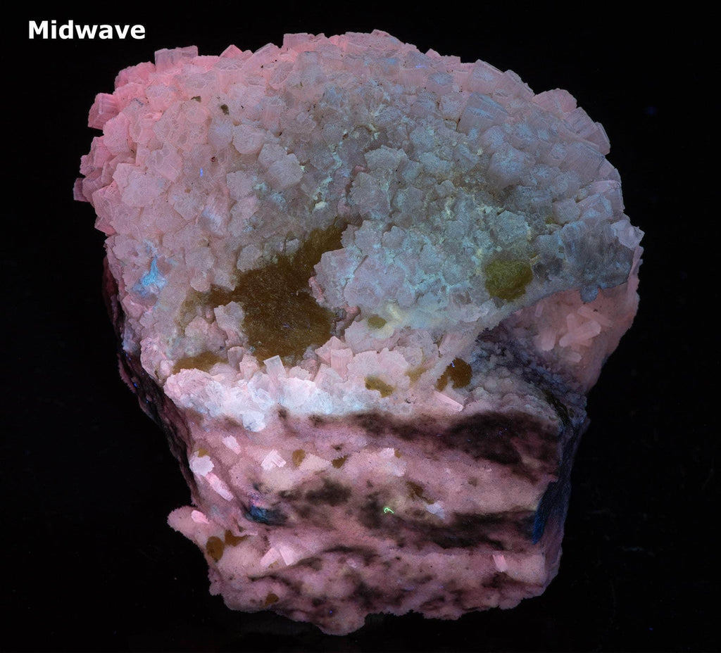Yellow sulphur crystals sit atop an aragonite matrix