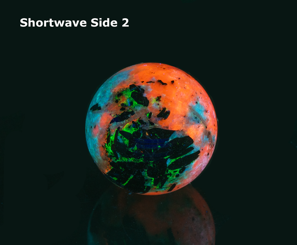 An incredibly bright and colorful, fluorescent sodalite sphere from Greenland