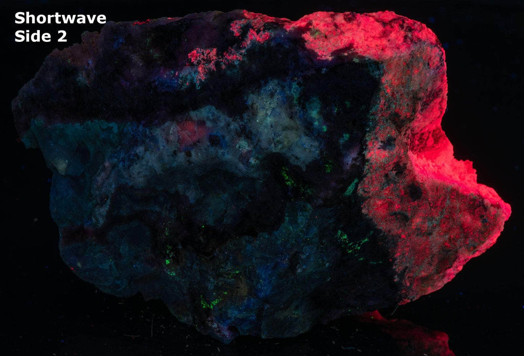 An incredible, unusual gemmy and extremely tenebrescent tugtupite specimen from Kangerlussaq. Vugs with large and well-formed, gemmy tugtupite crystals 