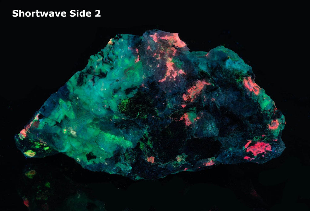 a fluorescent mineral specimen of tugtupite, chkalovite under shortwave UV light