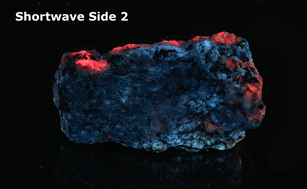 A piece of our highly sought after "Fantasy Rock". This piece features rich tugtupite that fluoresces a deep cherry red under shortwave UV.