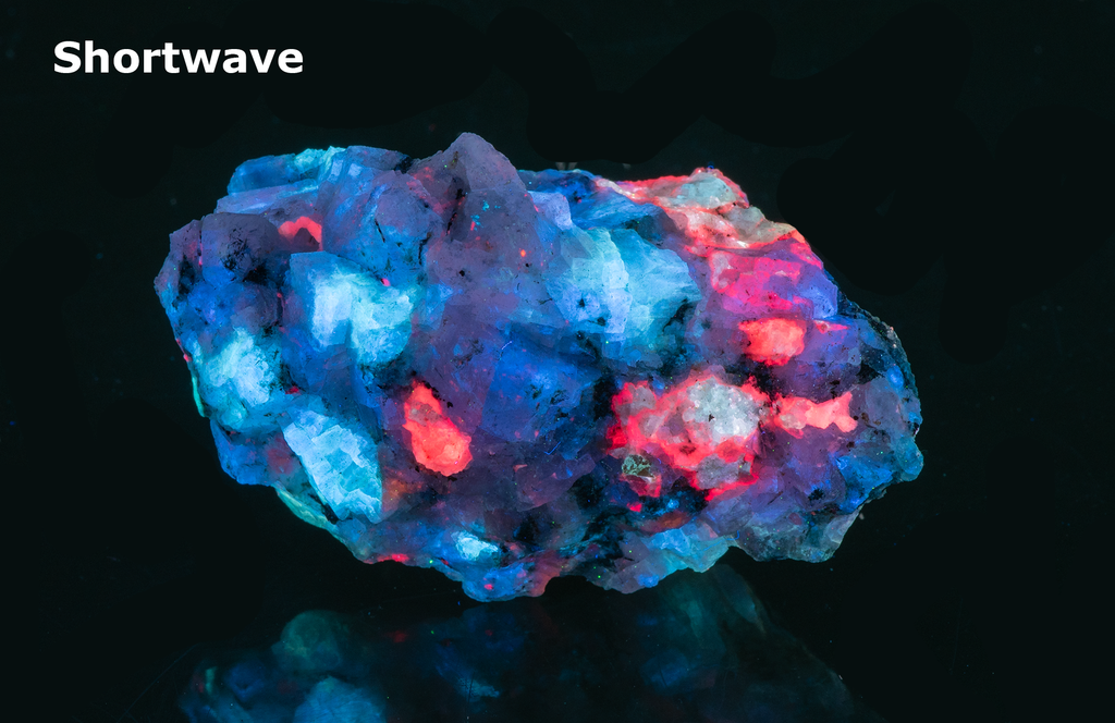 A piece of our highly sought after "Fantasy Rock". This piece features rich tugtupite that fluoresces a deep cherry red under shortwave UV.