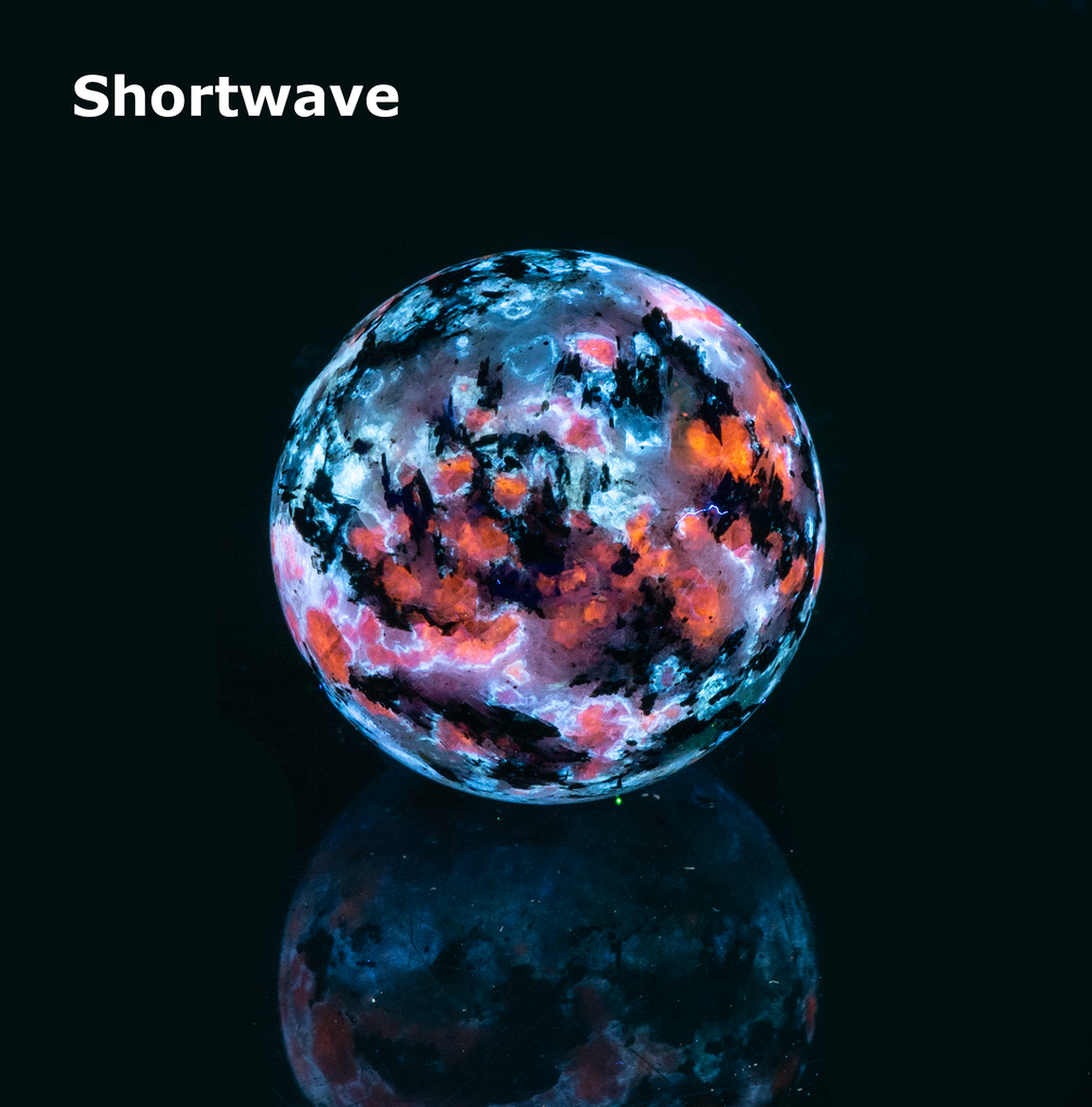 The main minerals on this sphere are blue analcime, orange fluorescent sodalite, black arfvedsonite crystals