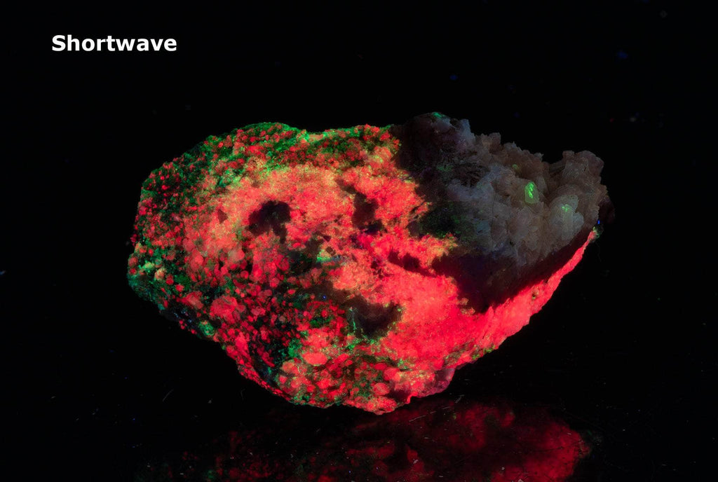 A smaller piece of our larger Kangerlussaq tugtupite specimens containing small tugtupite crystals dispersed throughout the matrix. 