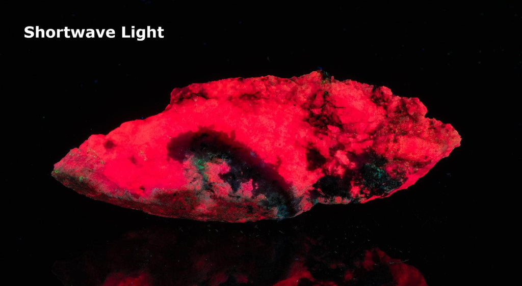 gem red tugtupite under shortwave UV light