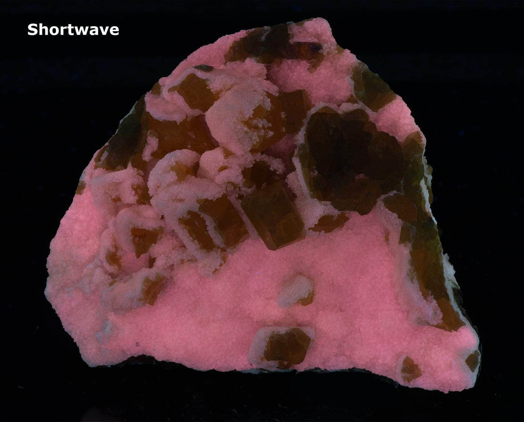 Yellow sulphur crystals sit atop an aragonite matrix