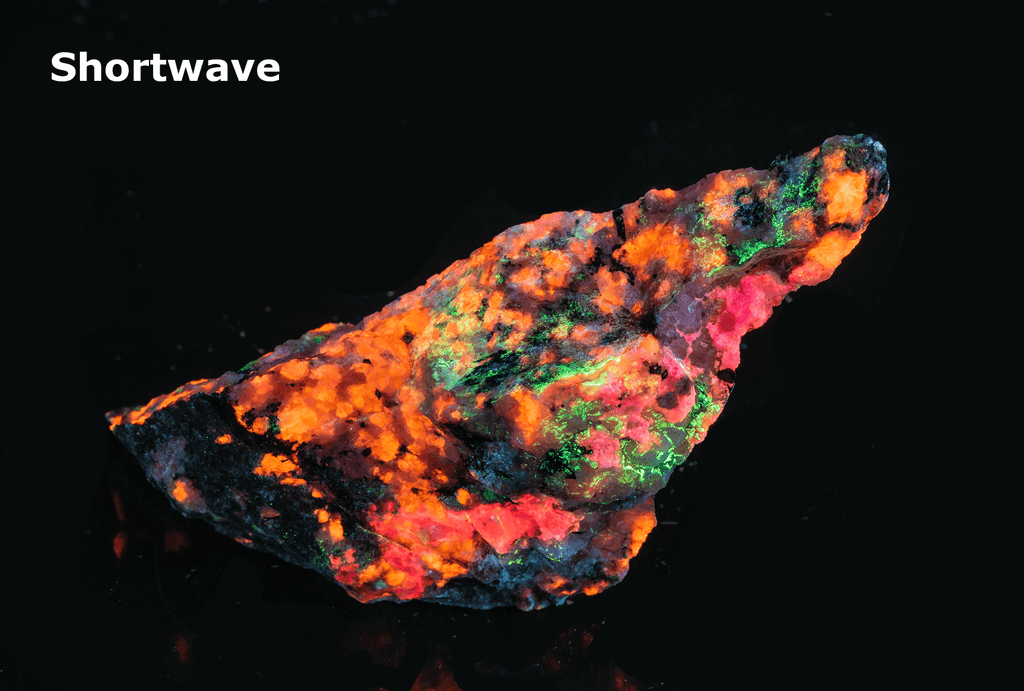tugtupite (cherry red under shortwave UV light), fluorecent sodalite (orange) and black arfvedsonite