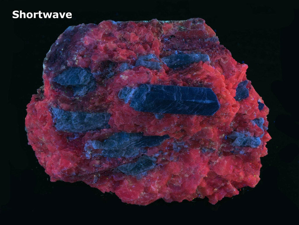 Large, green, terminated apatite crystals sit on a matrix of orange calcite 