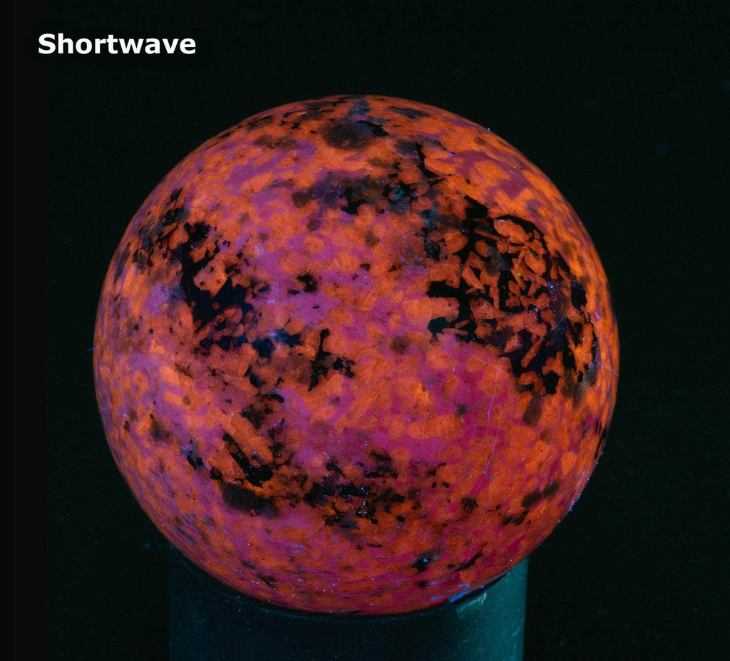 A sphere of fluorescent sodalite, brightest under longwave.