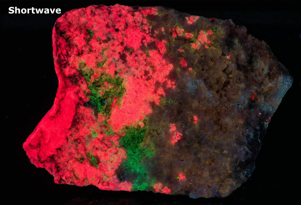 An incredible, unusual gemmy and extremely tenebrescent tugtupite specimen from Kangerlussaq. Vugs with large and well-formed, gemmy tugtupite crystals 